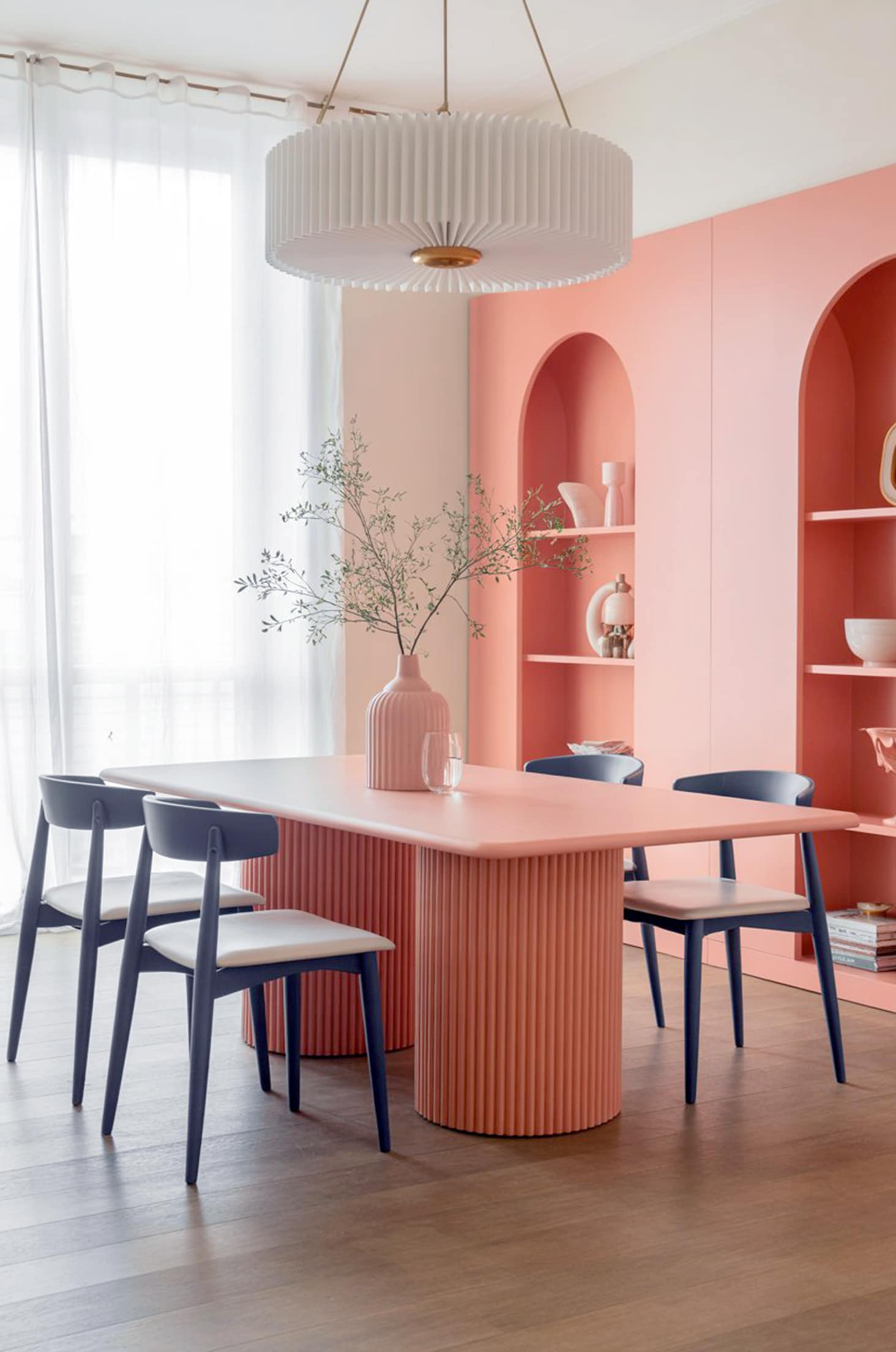 Chic coral & navy dining room with modern pastel furniture