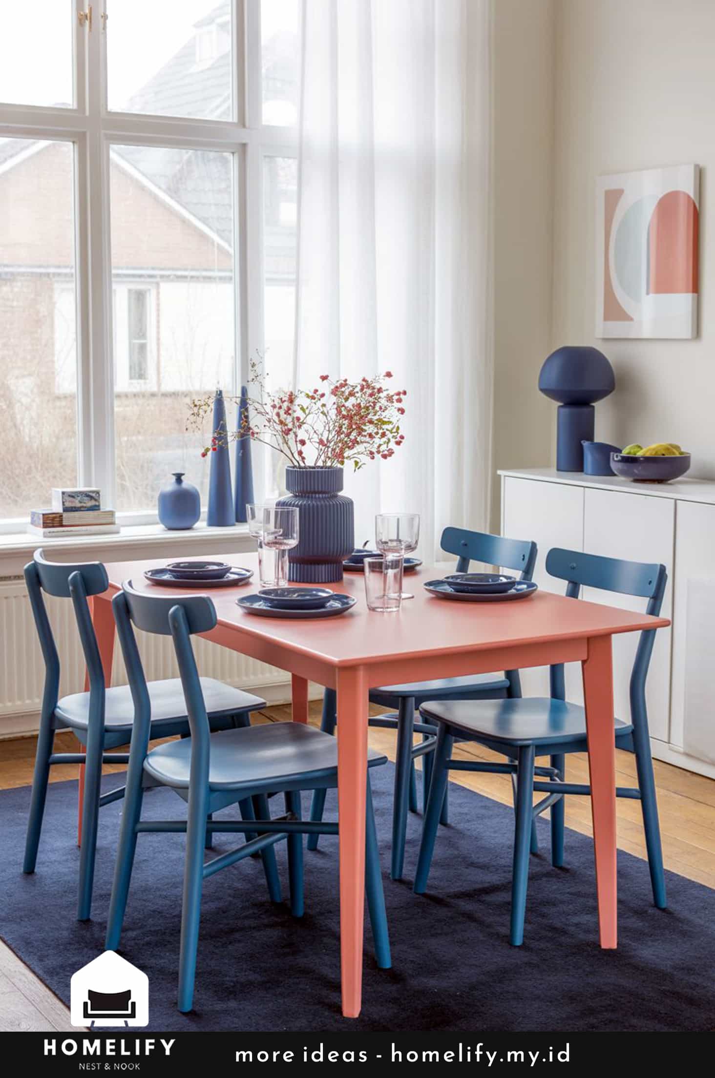 Chic nordic dining room with coral table and blue chairs