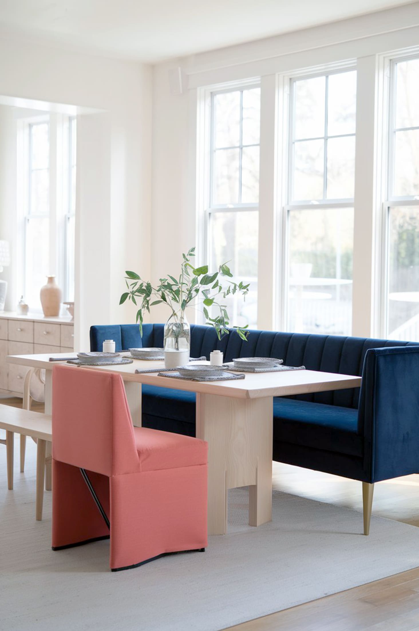 Chic pastel paradise blue & coral furniture in a sunlit room