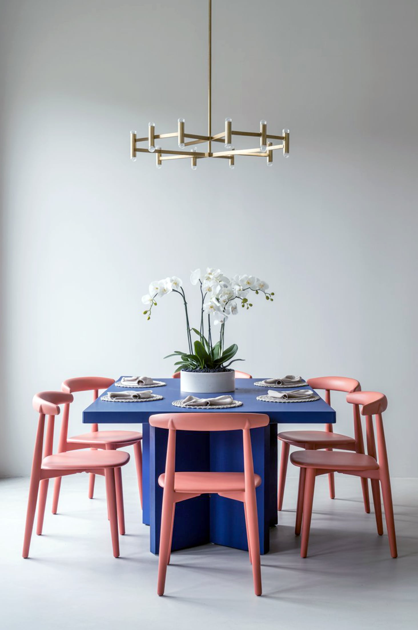 Chic pastel paradise coral chairs & navy table in a vibrant dining room