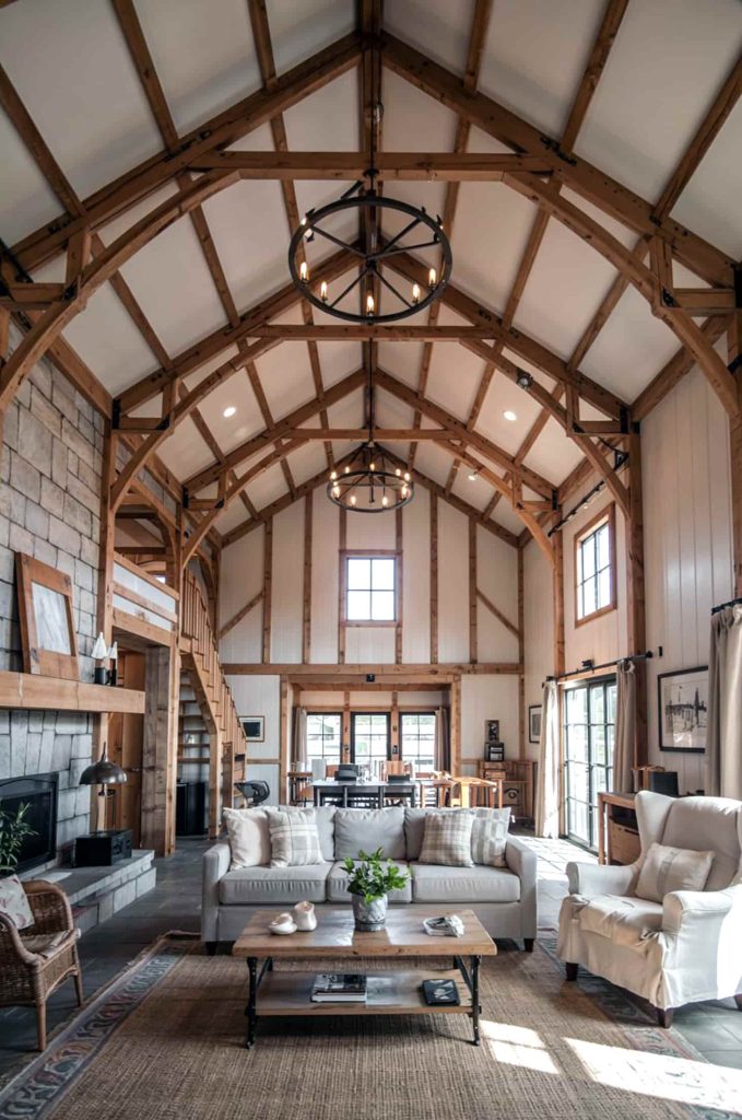 Grand barndominium living room with vaulted ceilings and exposed beams