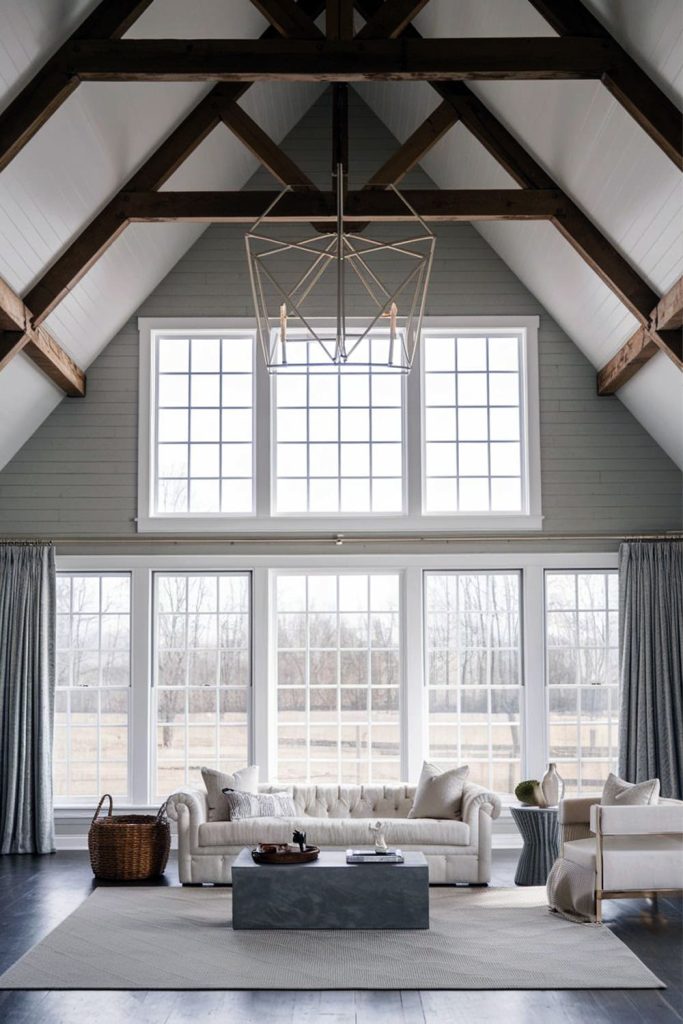 Modern hamptons barndominium living room with bold chandelier