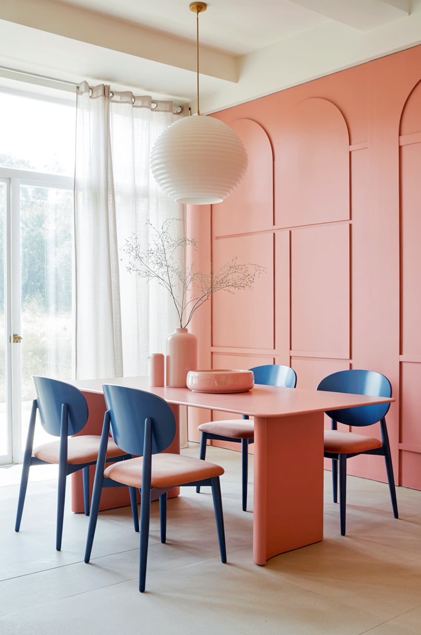Stylish coral & navy dining room with modern pastel touches