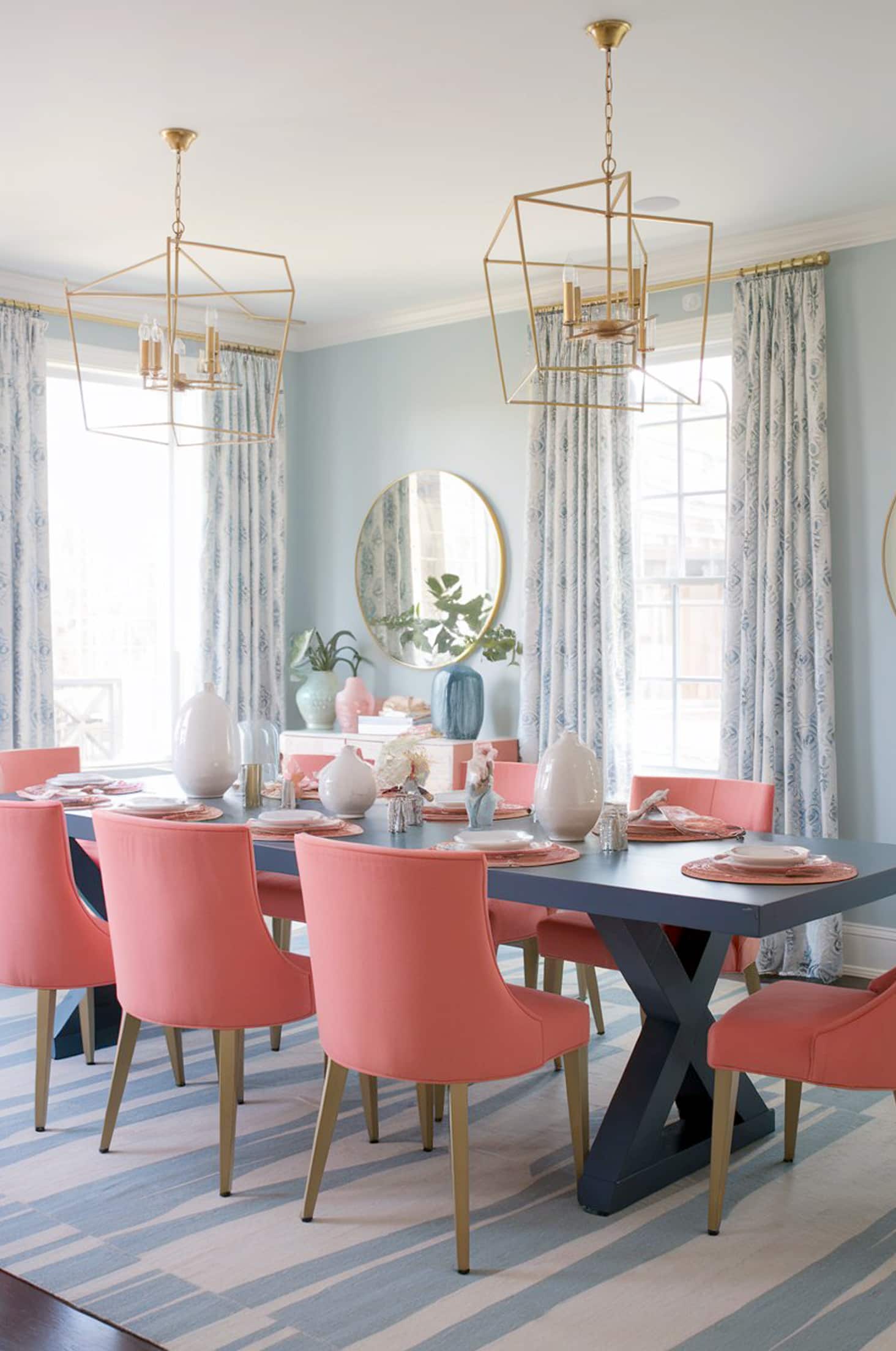 Vibrant dining room with coral chairs & navy dining table